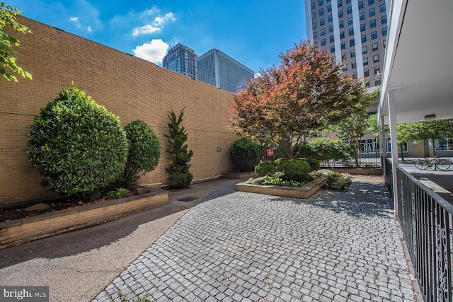 view of property's community with fence and a patio