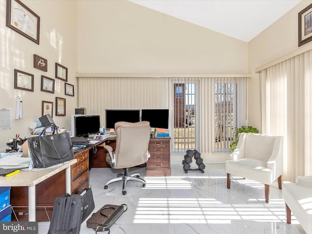 home office with high vaulted ceiling and marble finish floor