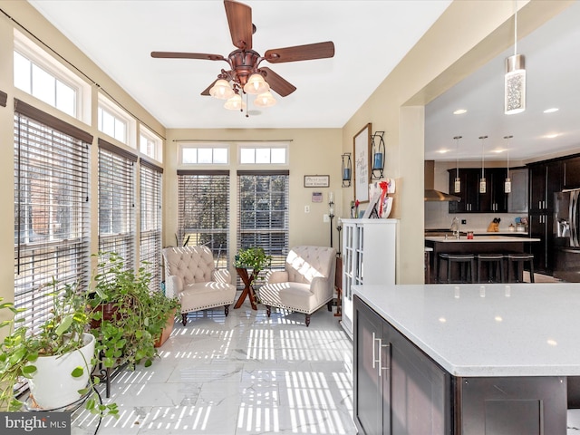 interior space with a sink and ceiling fan