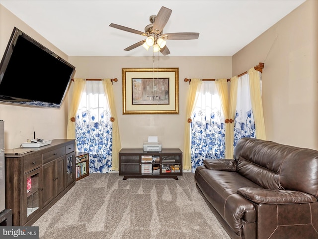 sitting room with carpet floors and ceiling fan