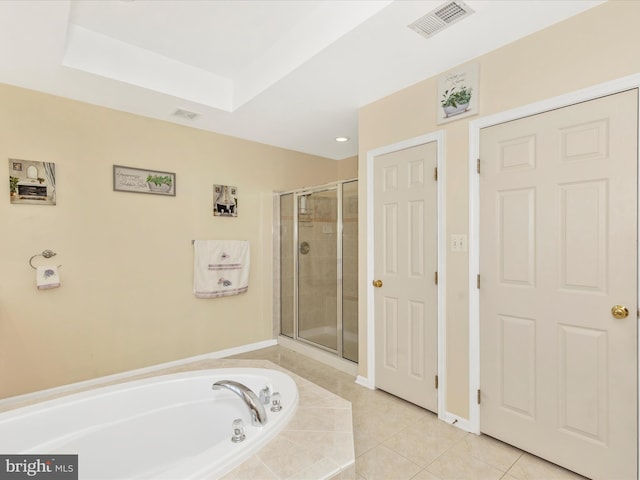 bathroom with tile patterned floors, visible vents, a garden tub, a stall shower, and a raised ceiling