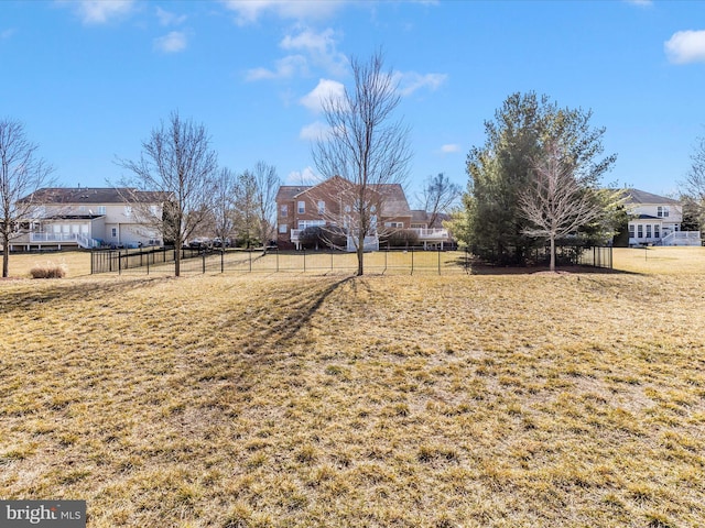 view of yard with a residential view and fence