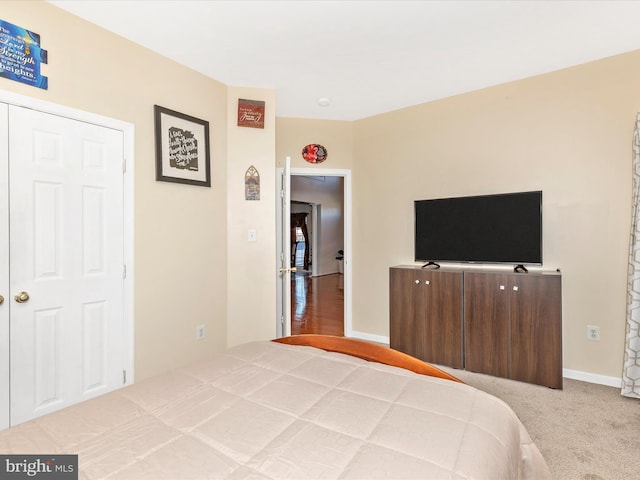 carpeted bedroom featuring baseboards