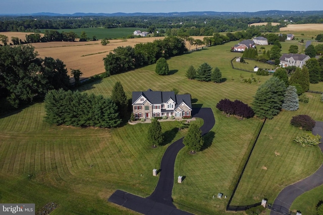 birds eye view of property with a rural view