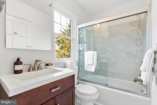 full bathroom featuring shower / bath combination with glass door, vanity, and toilet