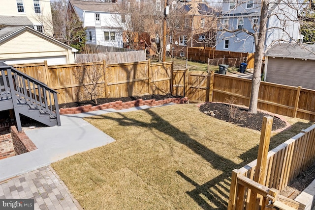 view of yard featuring a fenced backyard and a residential view