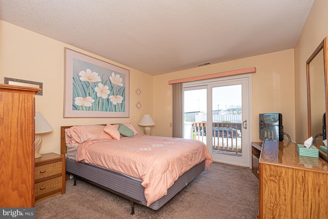 bedroom with a textured ceiling, access to outside, carpet flooring, and visible vents