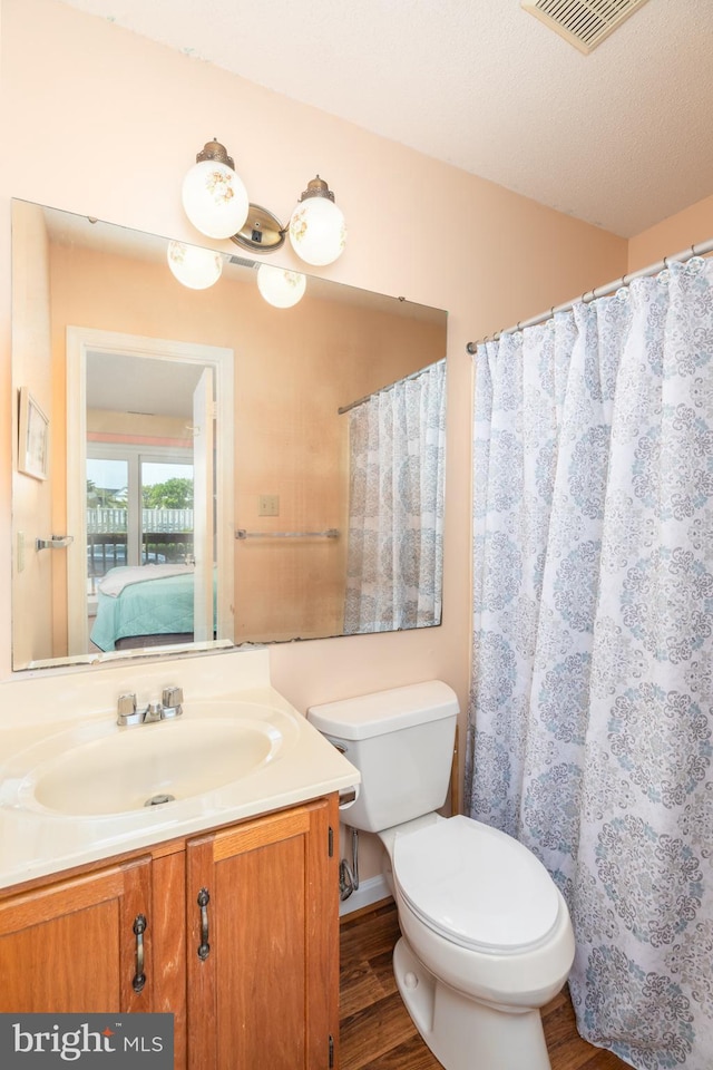 14501 Tunnel Ave Unit 10602, Ocean City, MD 21842 - bathroom with vanity, toilet, ensuite bathroom, wood finished floors, and visible vents