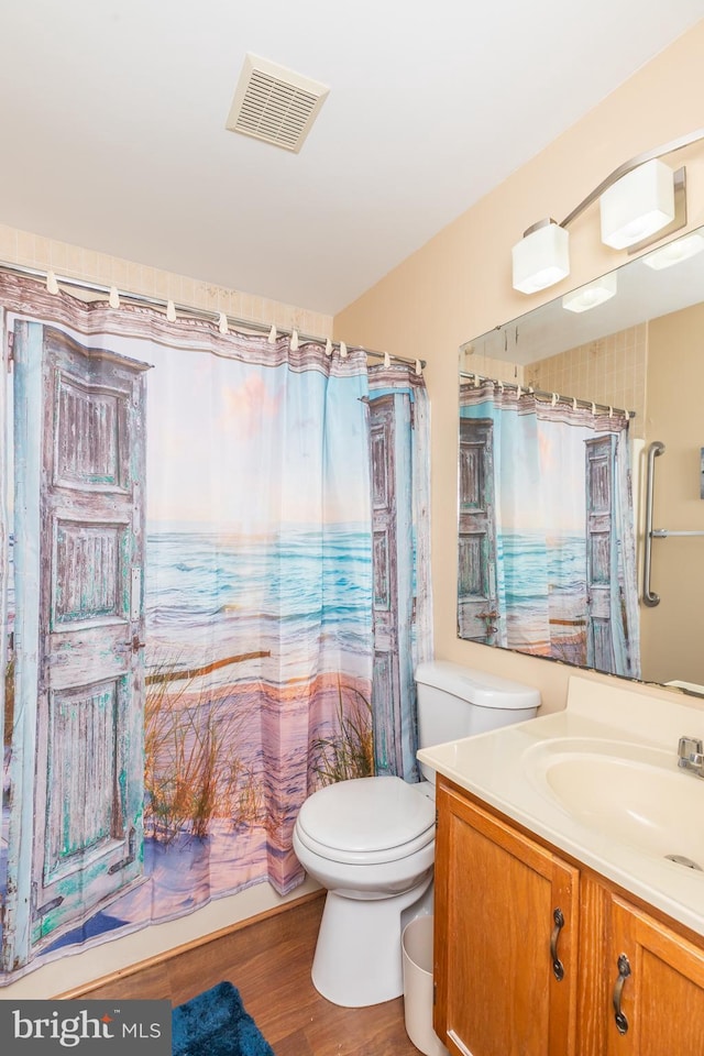 14501 Tunnel Ave Unit 10602, Ocean City, MD 21842 - bathroom with visible vents, vanity, curtained shower, wood finished floors, and toilet