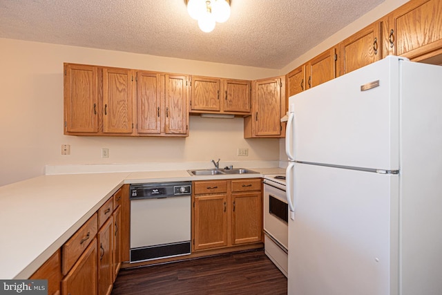 kitchen featuring dark wood-style floors, white appliances, light countertops, and a sink