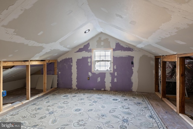 additional living space featuring lofted ceiling