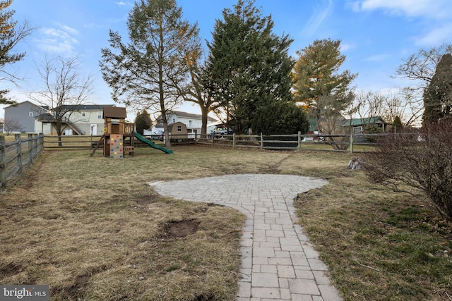 view of yard with a playground and a fenced backyard