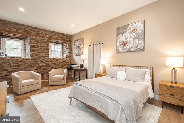 bedroom featuring light wood-type flooring, multiple windows, and recessed lighting