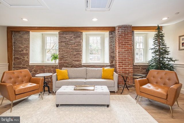 living room with a healthy amount of sunlight, visible vents, wood finished floors, and recessed lighting