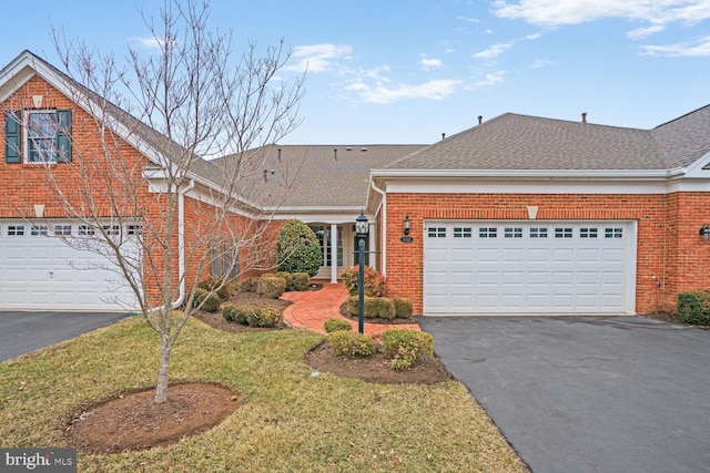 view of front of property with a garage, brick siding, driveway, and a shingled roof