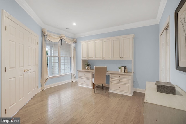 home office with light wood-style flooring, ornamental molding, baseboards, and built in study area