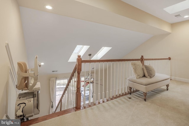 living area with vaulted ceiling with skylight, carpet, visible vents, and recessed lighting