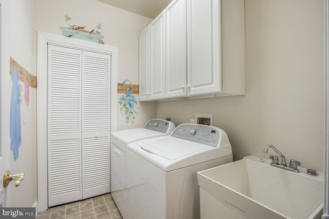 clothes washing area with light tile patterned flooring, cabinet space, a sink, and separate washer and dryer