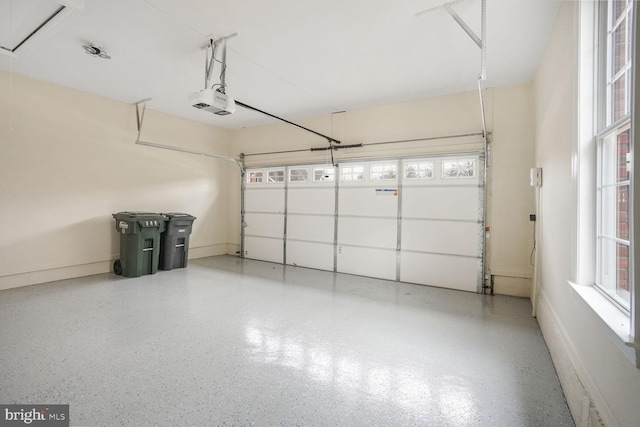 garage with a garage door opener and baseboards