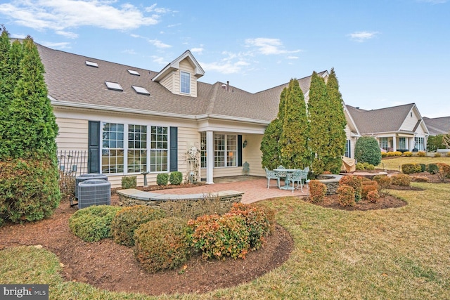 back of house with a yard, central AC, a patio, and a shingled roof