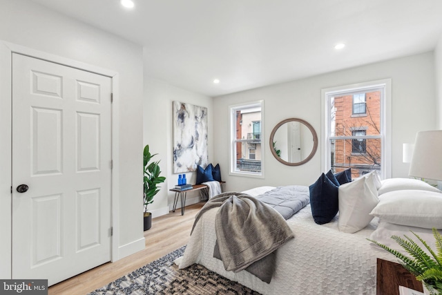 bedroom with baseboards, light wood-style flooring, and recessed lighting