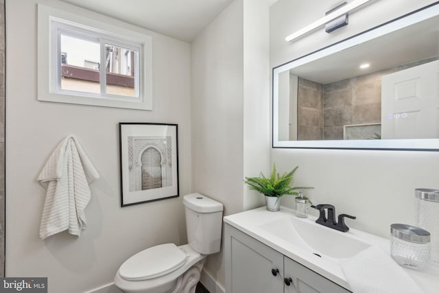 bathroom featuring toilet and vanity