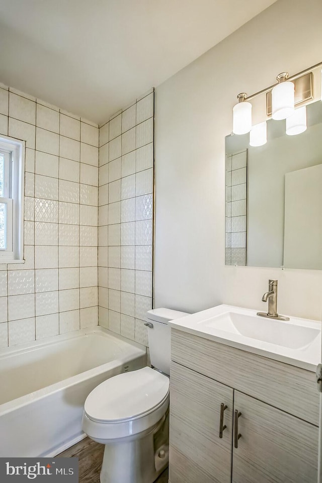 bathroom with shower / washtub combination, vanity, toilet, and wood finished floors