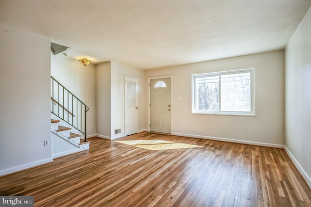 entryway featuring stairs, baseboards, and hardwood / wood-style flooring