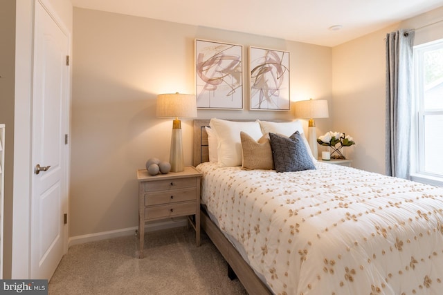 bedroom featuring carpet flooring and baseboards