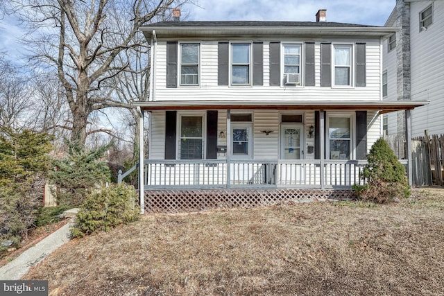 view of front of home with covered porch and a chimney