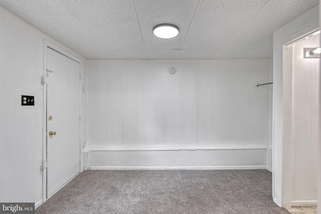 interior space with carpet flooring and a drop ceiling