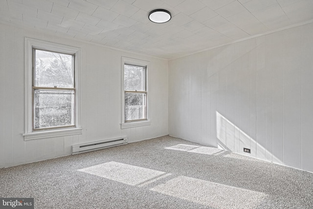 carpeted empty room featuring ornamental molding and a baseboard radiator