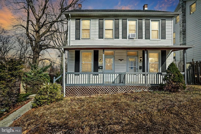 view of front of house with covered porch and a chimney