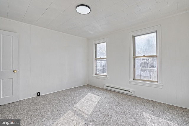 unfurnished room featuring carpet floors and a baseboard heating unit