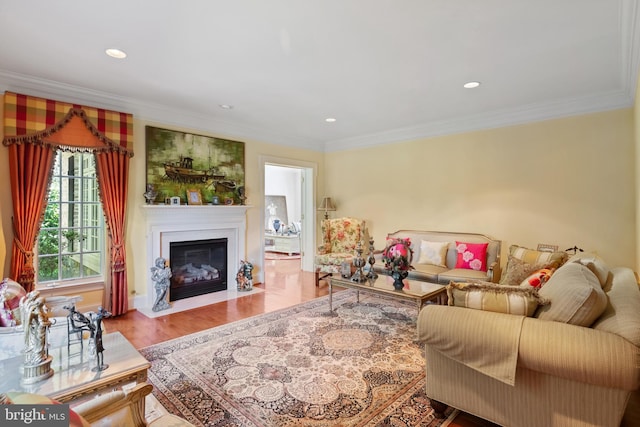 living room with a fireplace with flush hearth, ornamental molding, wood finished floors, and recessed lighting