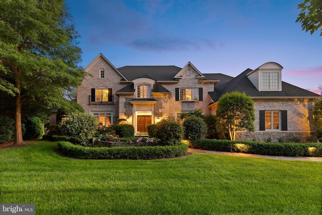 french country home with a lawn