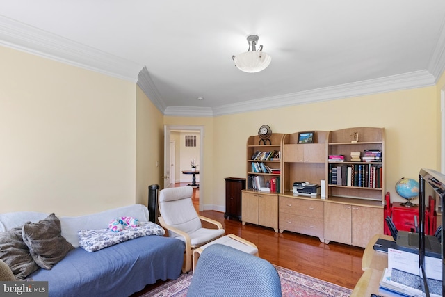 interior space featuring ornamental molding, baseboards, and wood finished floors