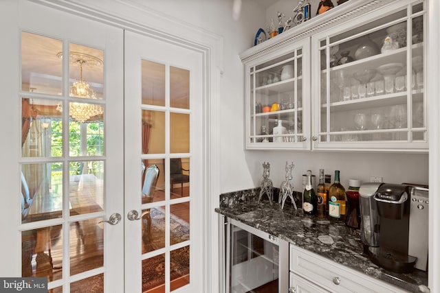 bar with beverage cooler, french doors, and a dry bar