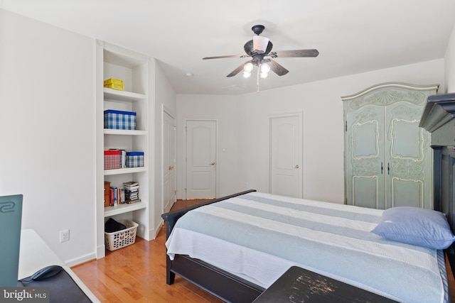 bedroom with baseboards, a ceiling fan, and wood finished floors