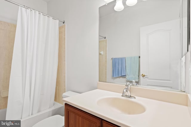 full bathroom featuring toilet, shower / bath combo with shower curtain, and vanity