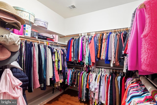 spacious closet featuring visible vents and wood finished floors