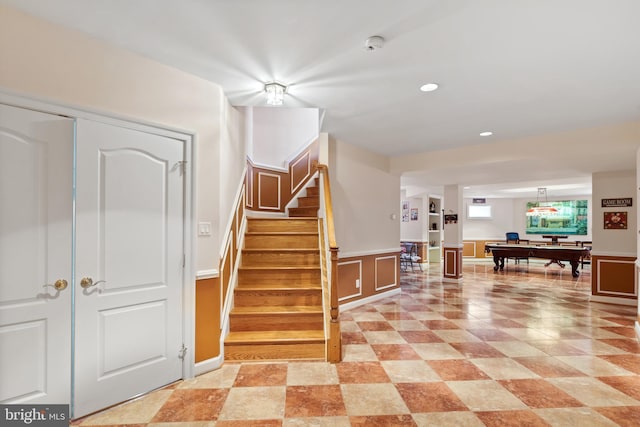 foyer entrance with recessed lighting, a wainscoted wall, pool table, and stairway