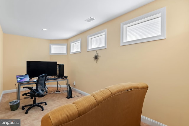 office area with visible vents, baseboards, and carpet flooring