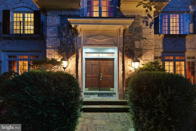 entrance to property with stone siding