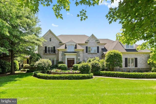 french provincial home with a front lawn