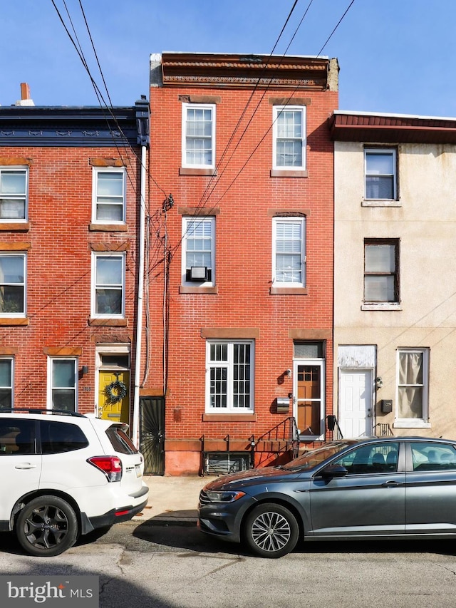 townhome / multi-family property featuring brick siding