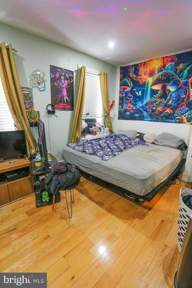 bedroom with hardwood / wood-style floors