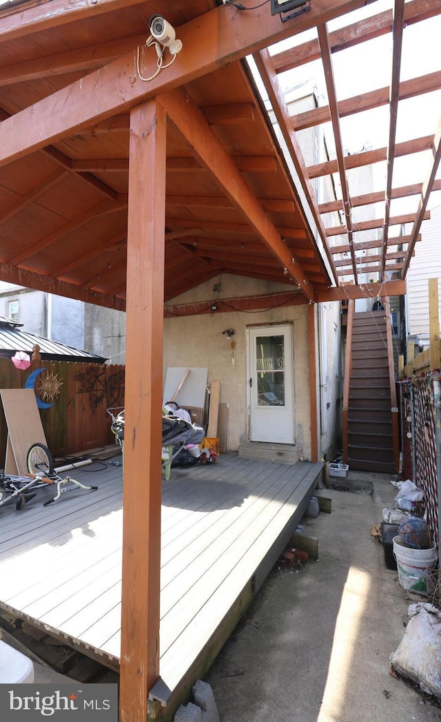 wooden terrace featuring fence