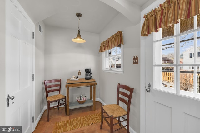 interior space featuring arched walkways, visible vents, and baseboards