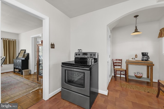 kitchen featuring baseboards, stainless steel electric range, and arched walkways